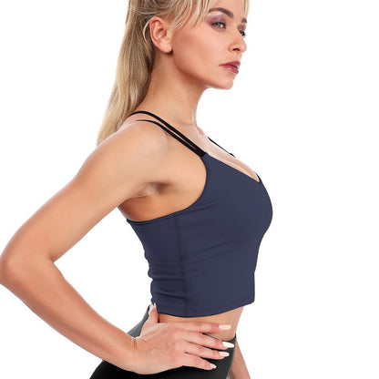 Woman wearing a navy blue sports bra on a white background