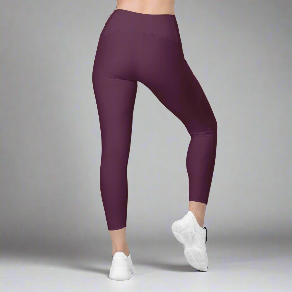 Purple leggings worn by a person on a gray background