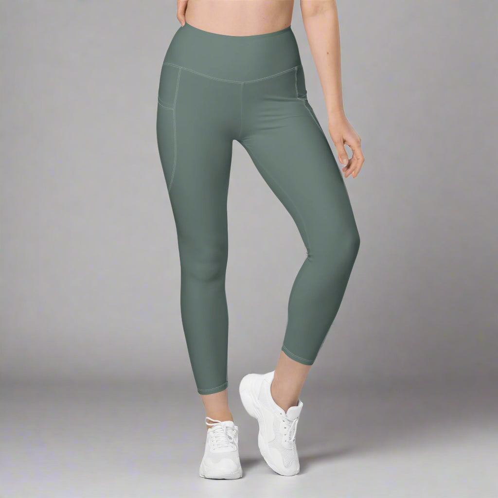 Green leggings worn by a person on a gray background