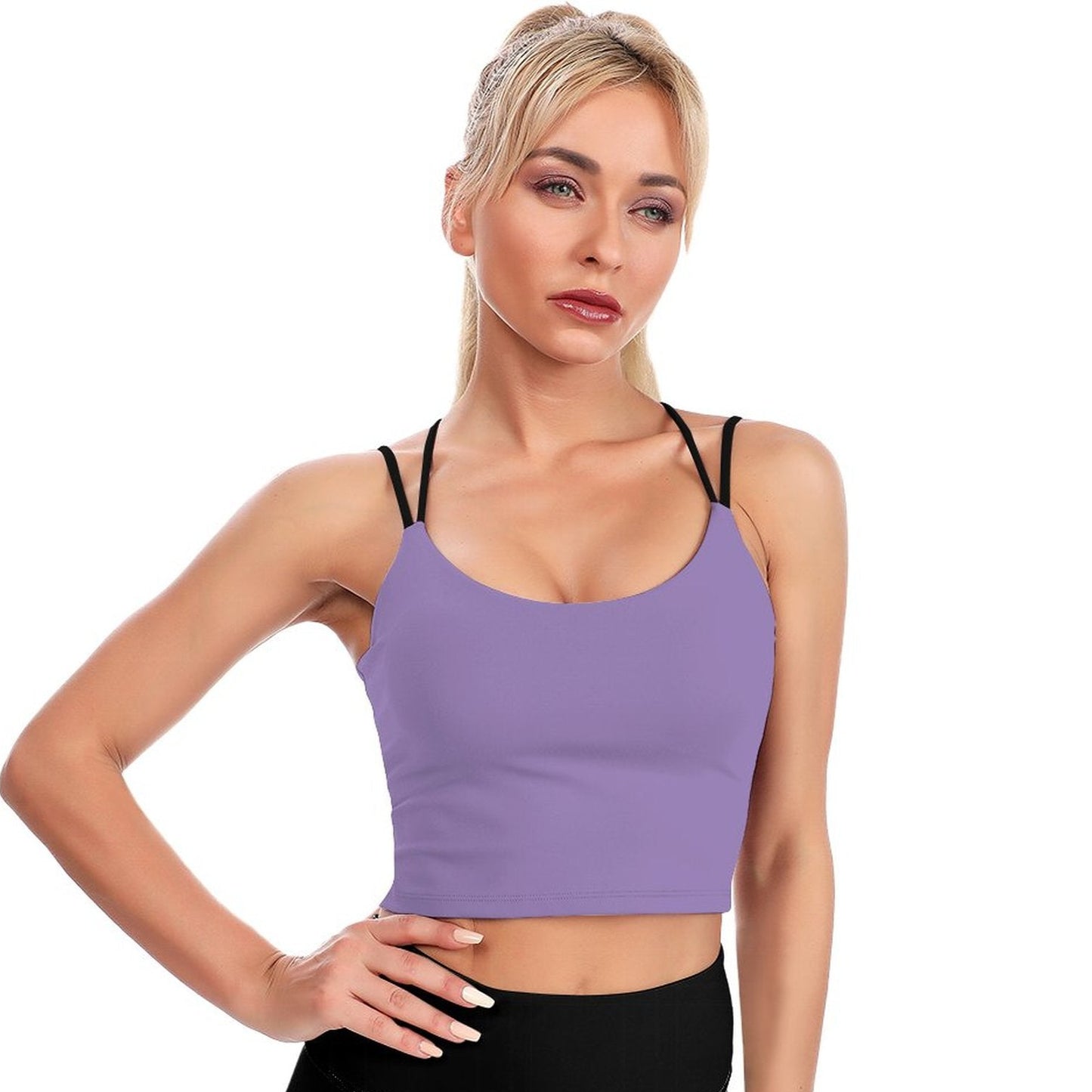 Woman wearing a purple sports bra and black leggings on a white background