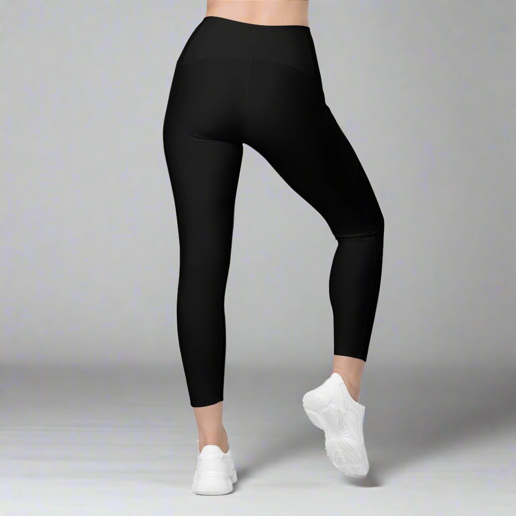 Black leggings worn by a person on a gray background