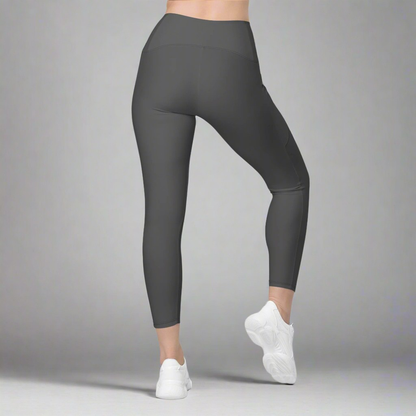 Dark gray leggings worn by a person on a gray background