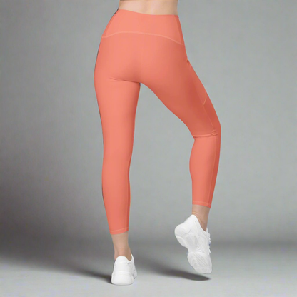 Coral leggings worn by a person on a gray background