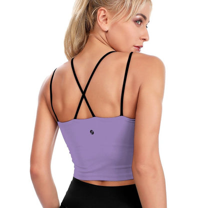 Woman wearing a purple sports bra with black straps on a white background
