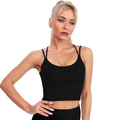 Woman wearing a black tank top against a white background