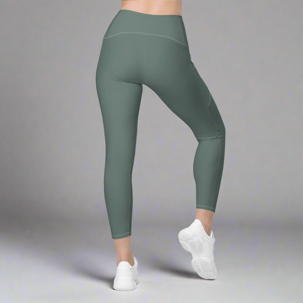 Green leggings worn by a person on a gray background