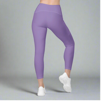 Purple leggings worn by a person on a gray background