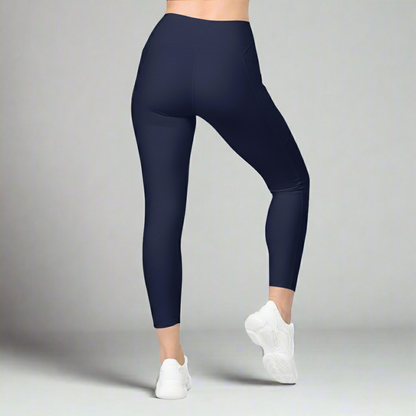 Navy blue leggings worn by a person on a gray background